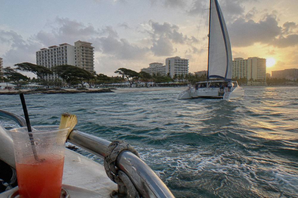 Sunset catamaran cruise passing the high-rise hotels along Palm Beach in Aruba